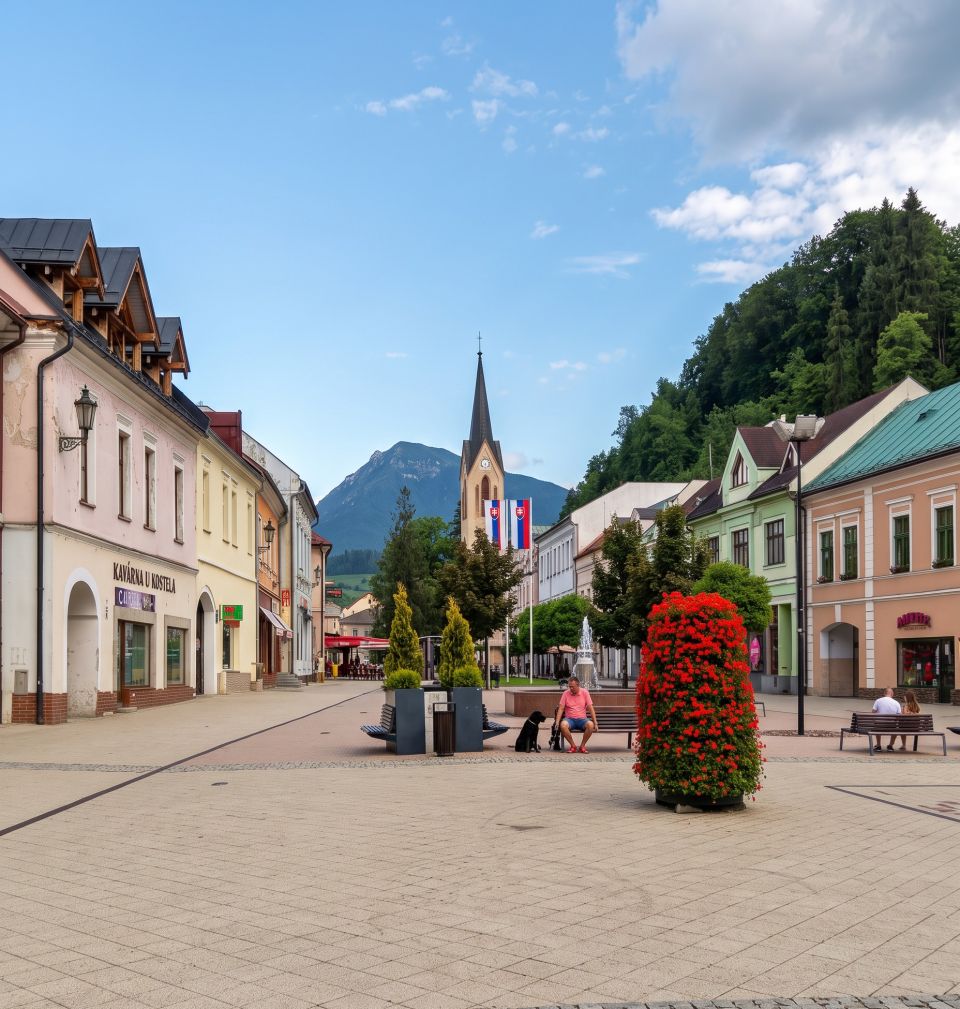 Town square in Dolný Kubín with the church and mountains in the background