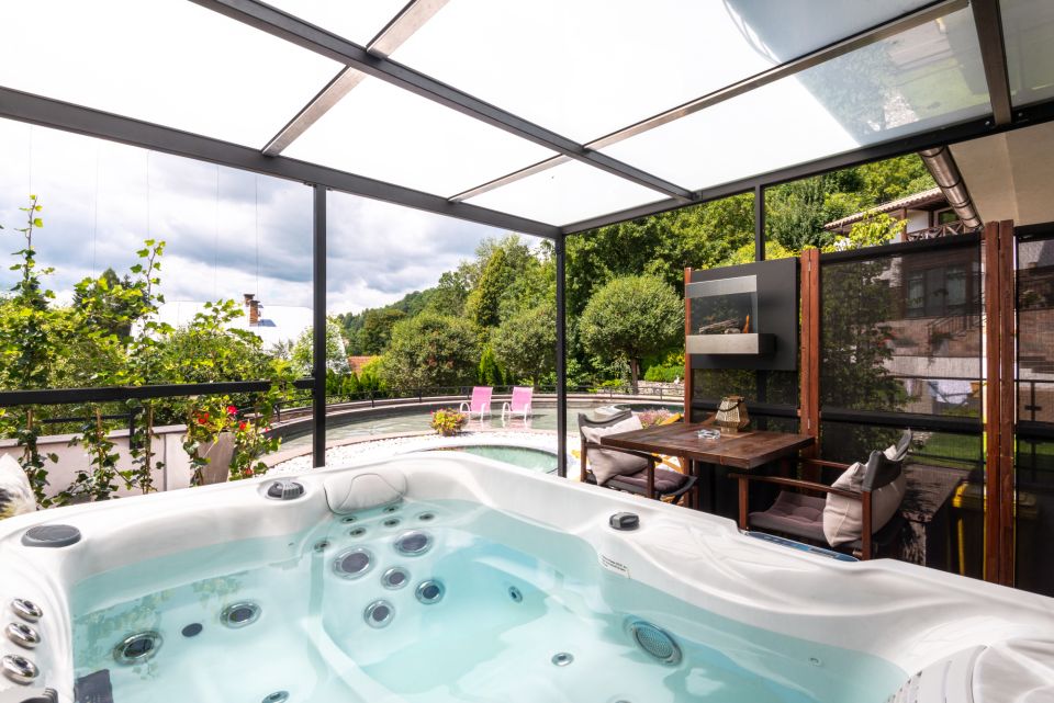 Hot tub under a glass roof with a view